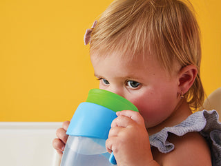 young girl drinking from 360 cup