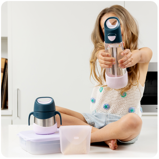 child sitting on kitchen counter with lunch products